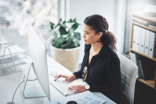 A healthcare practice manager works in an office.