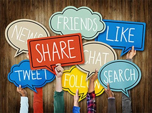Hands holding up signs with social media terms: friends, news, tweet, follow, like, share, chat and search.