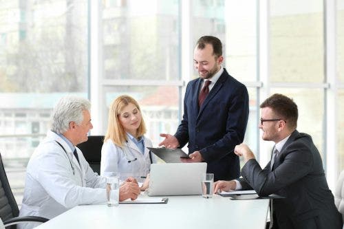 Team consultes while looking at business documents