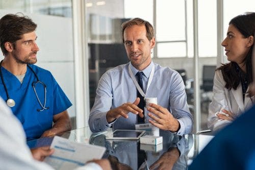 A hospital executive meets with the medical team.