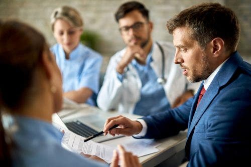 A healthcare marketing professional meets with a medical team.