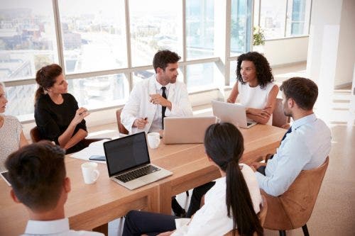 A hospital manager leads a staff meeting.