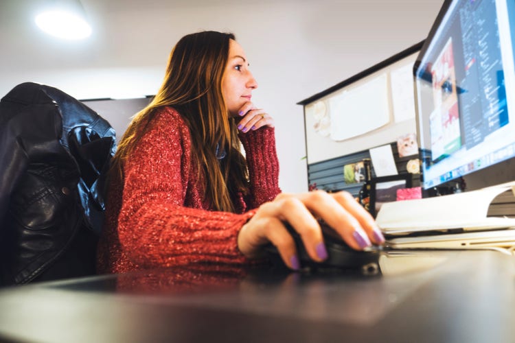 A clinical research administrator working on computer