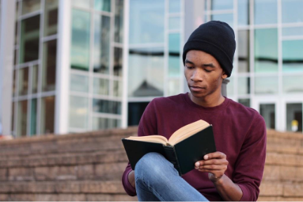 Healthcare MBA student studying with book in hand